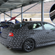 A Subaru WRX STI S209 test mule flanked by Subaru’s 1998 WRC rally car at Fuji International Speedway.